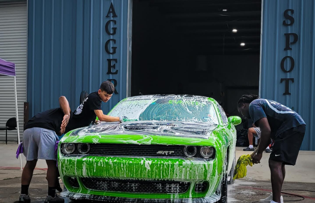 Rolling Water crew washing a green Dodge Challenger SRT
